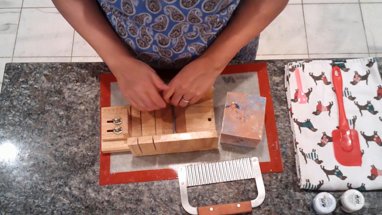 Cutting the amber and blue soap into bars