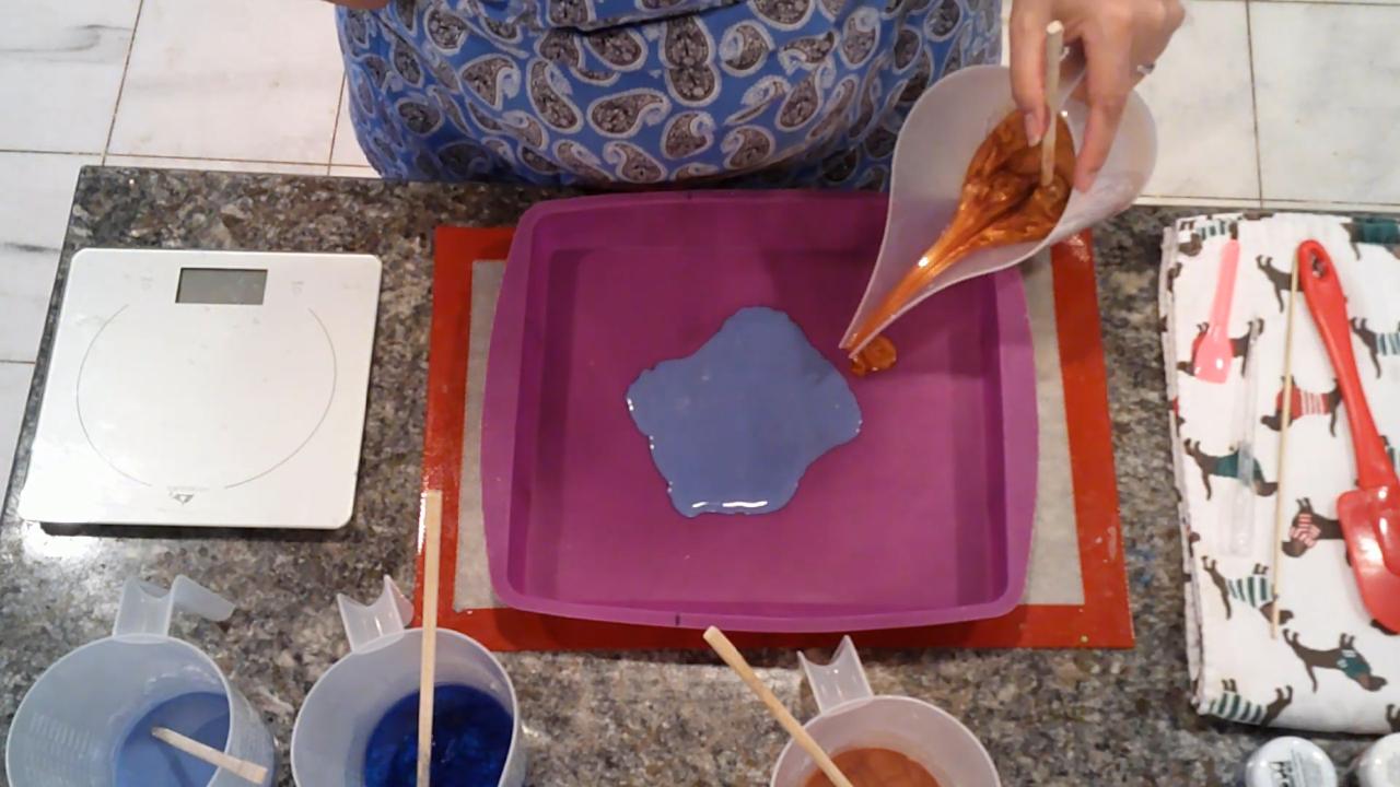 Pouring Blue Ice soap onto a silicone pan