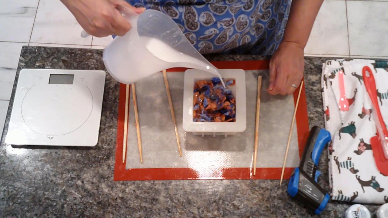Pouring white soap over the pressed pieces