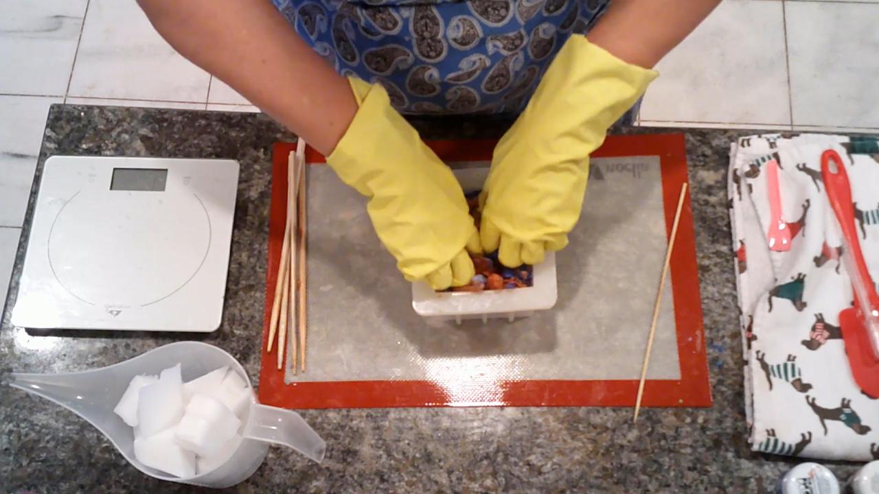Pressing the amber and blue soap into a square mold