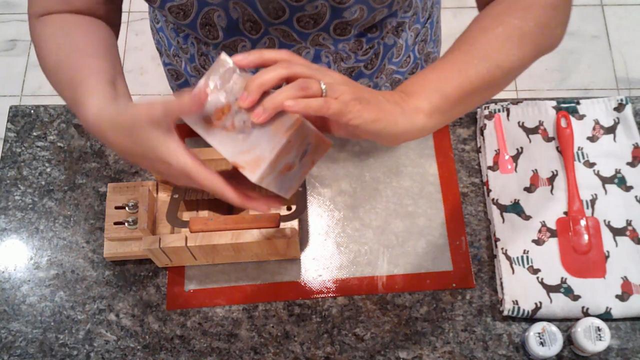 Unmolded amber and blue soap loaf in the cutter