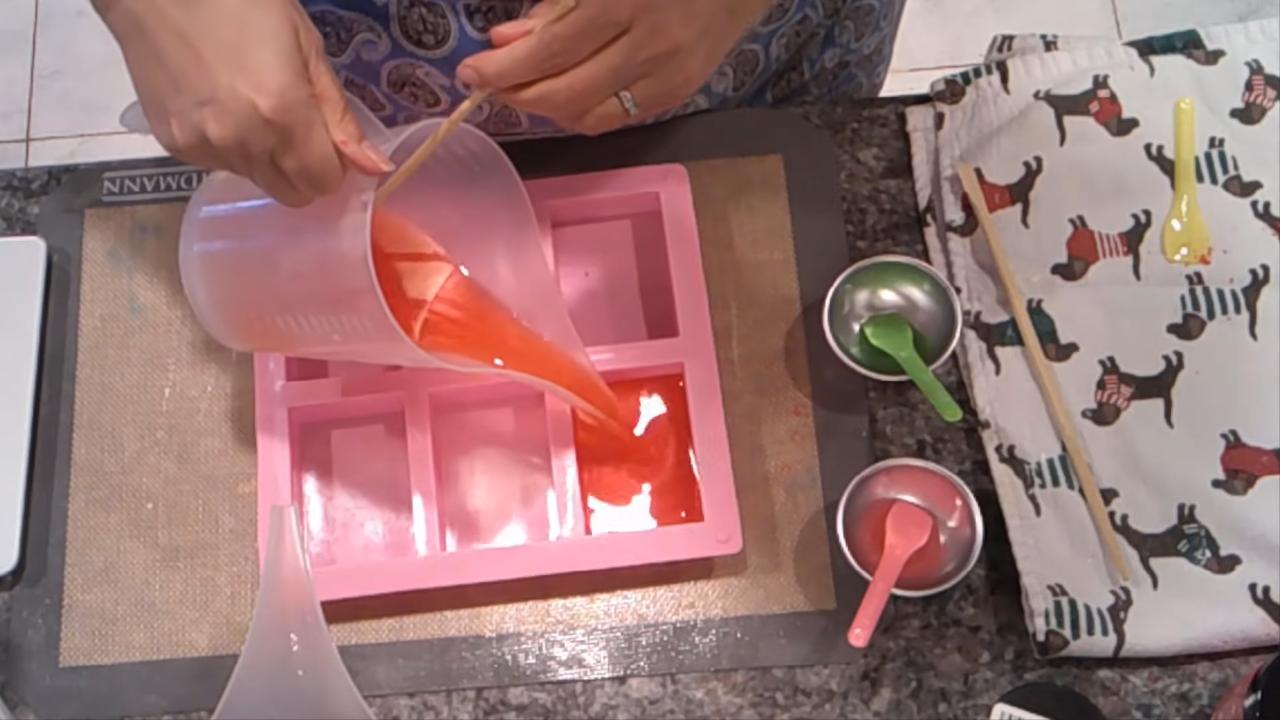 Pouring red soap into a cavity mold