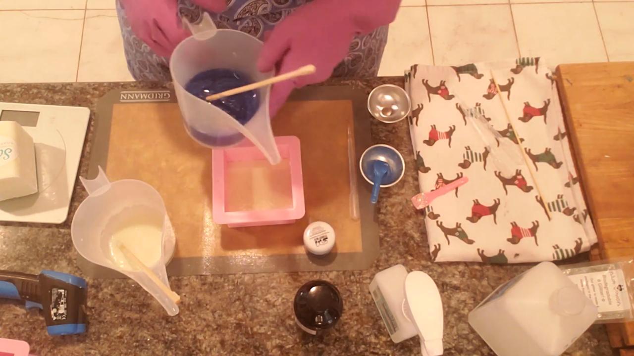 Pouring blue soap from up high over the white layer