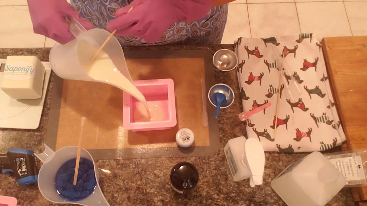 Pouring white avocado butter soap into a square mold