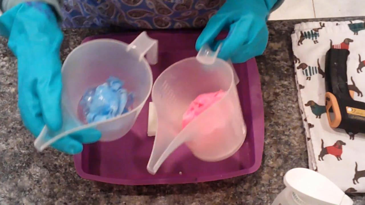 Melted blue and pink soap skins in pour cups