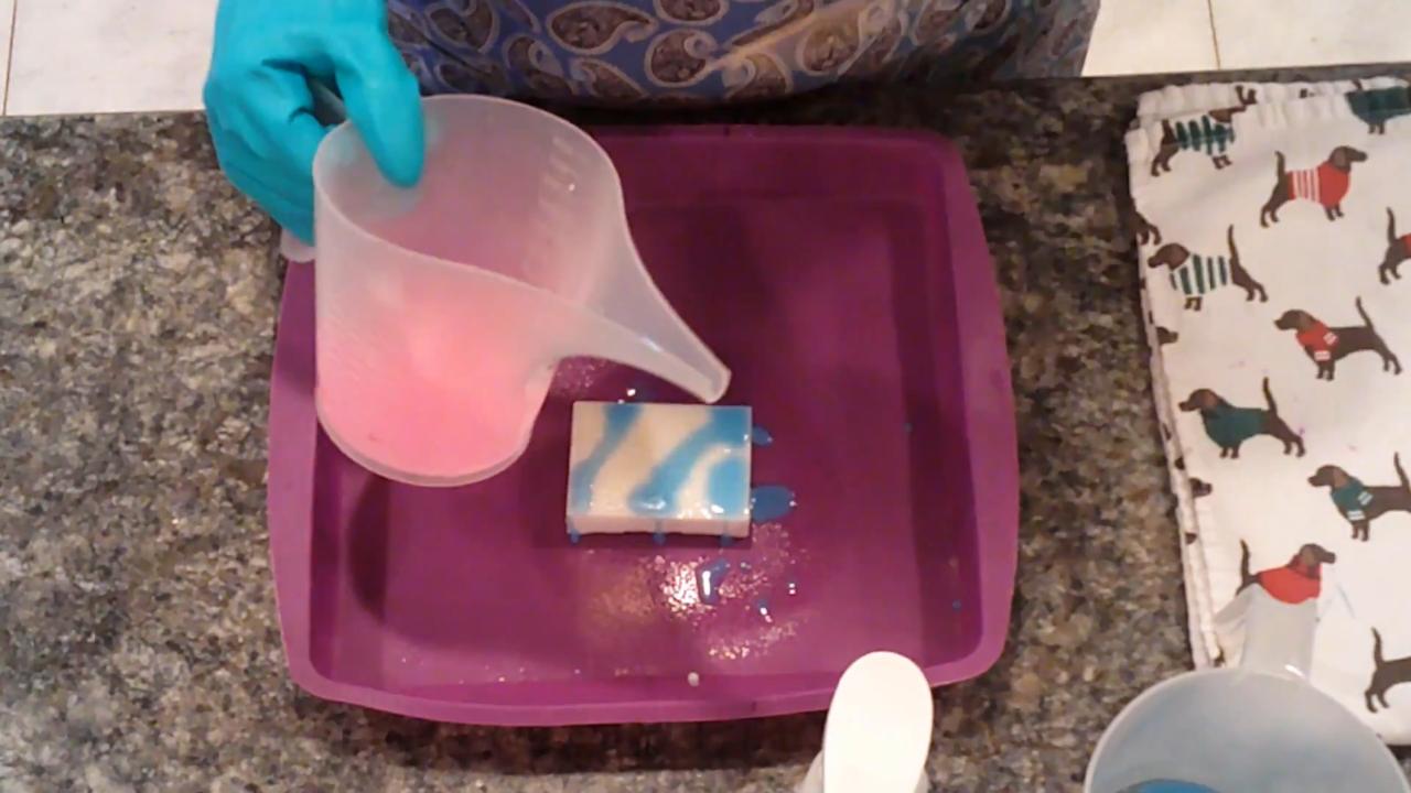 Drizzling pink soap over the bar