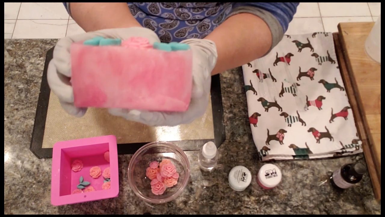 Cut blooming roses soap bar showing a subtle pink swirl