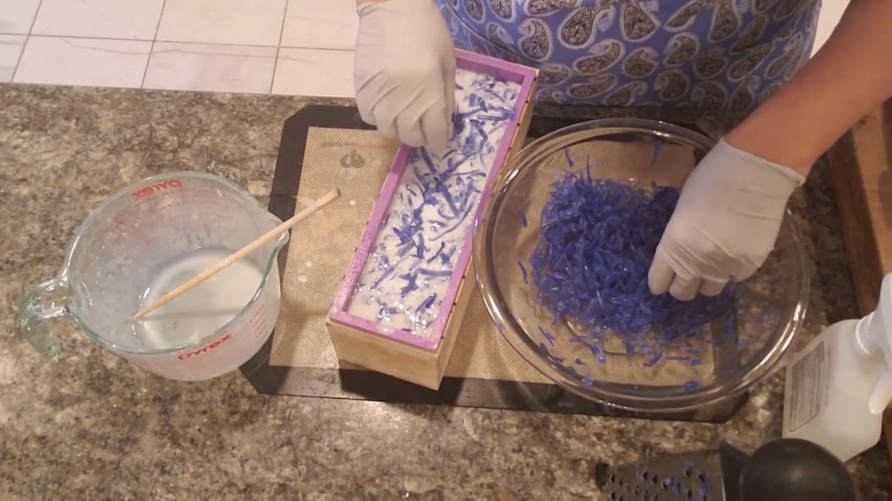 Sprinkling blue soap shreds over the top of the loaf
