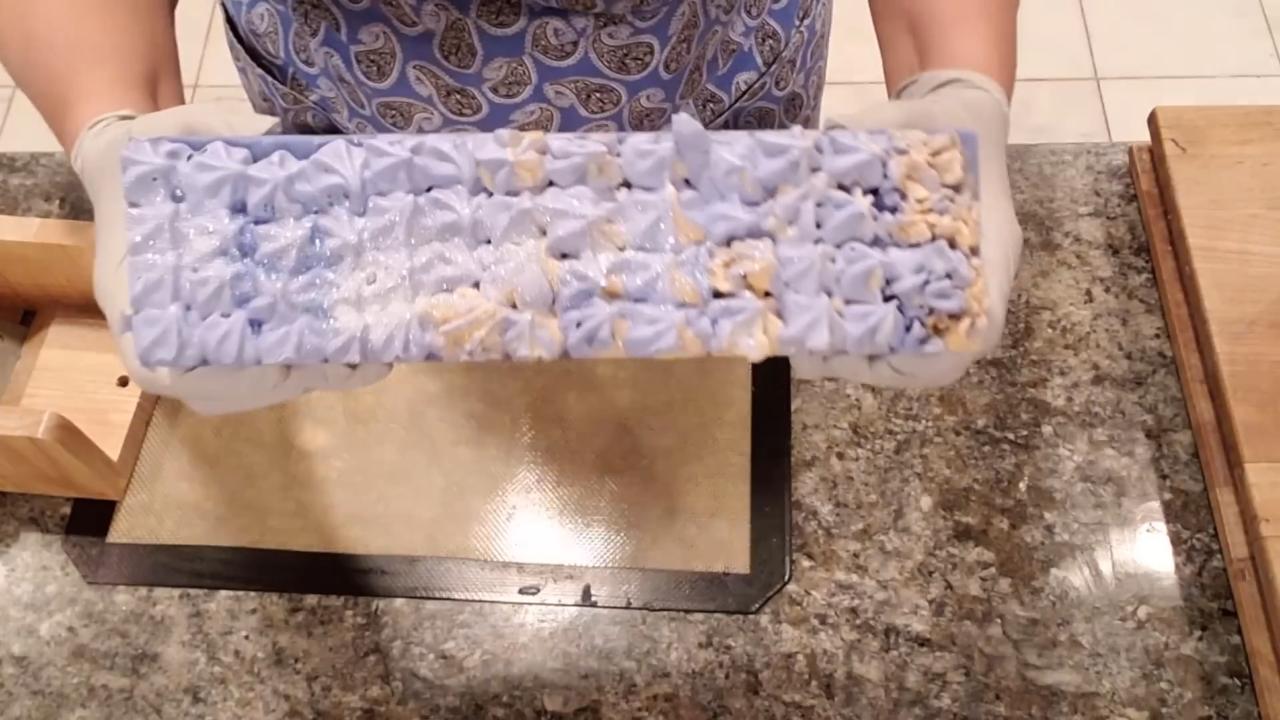 Unmolded blue and gold loaf with piped soap frosting