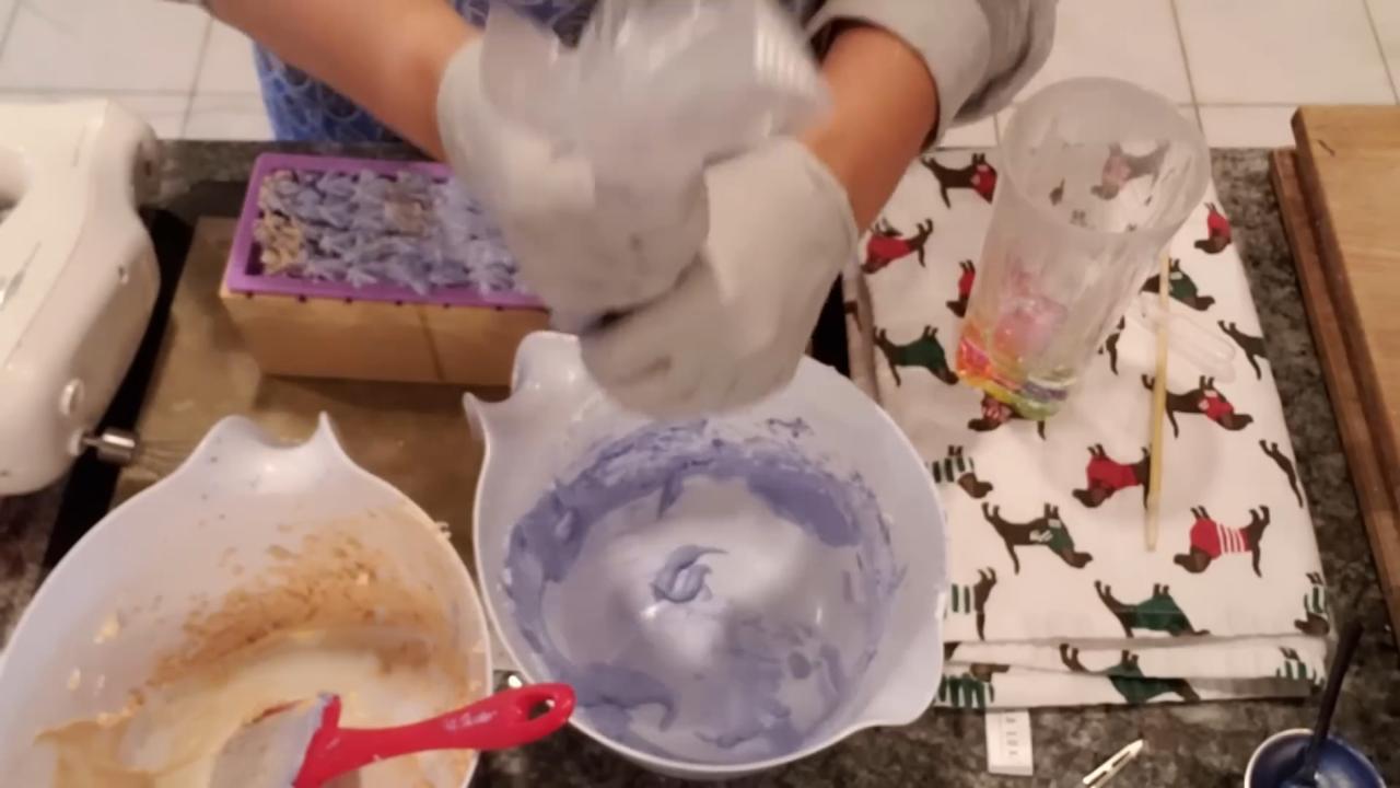 Piping soap frosting onto the blue and gold loaf