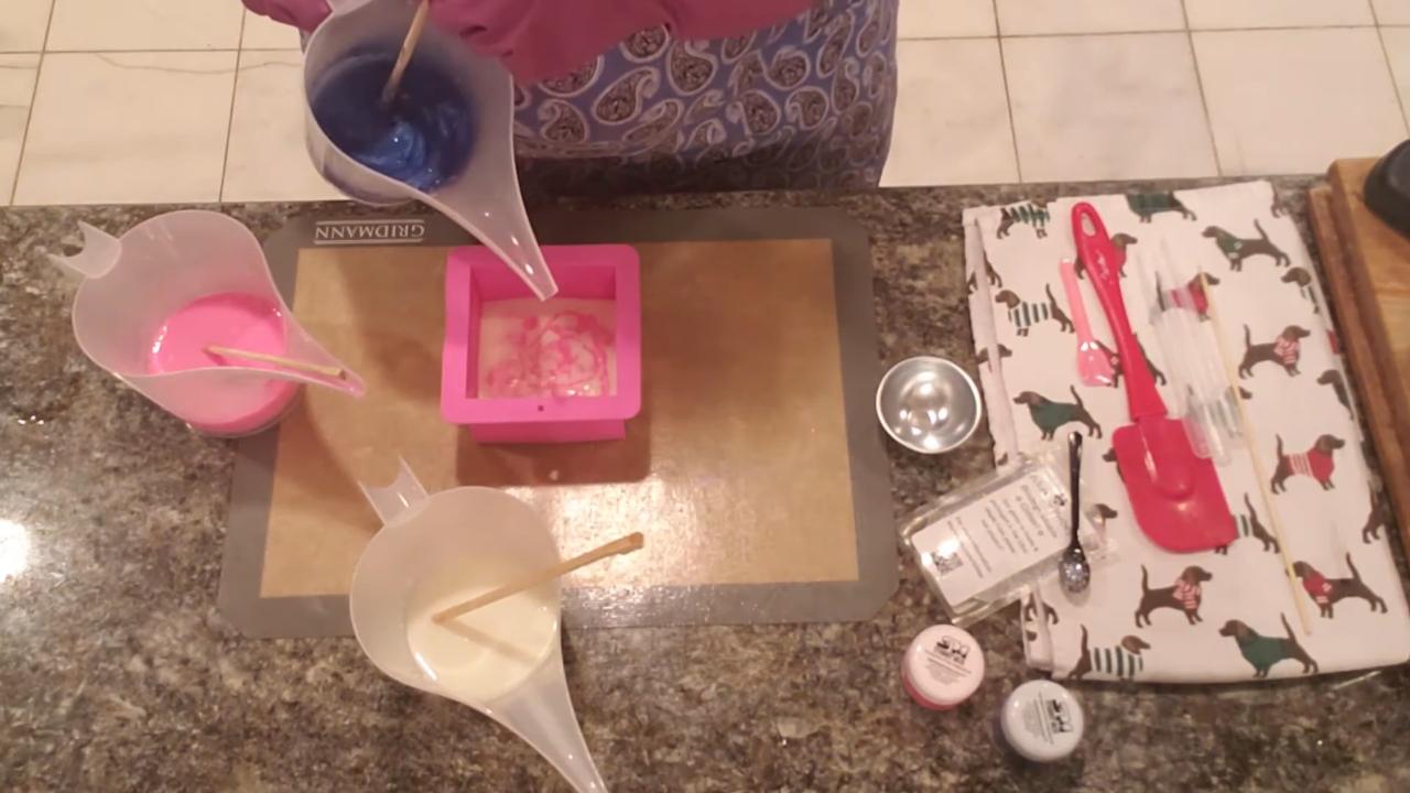 Pouring glittery blue soap into the mold