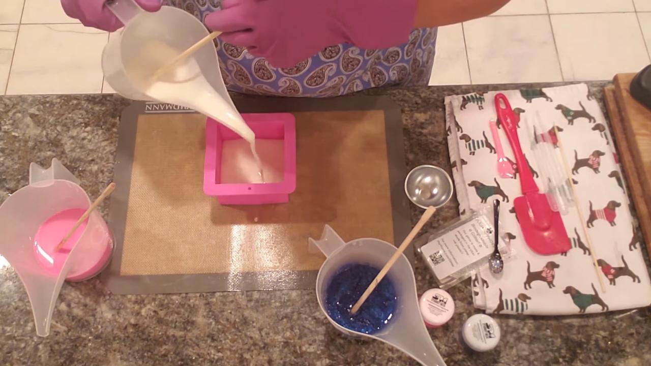 Pouring white shea butter soap into the mold