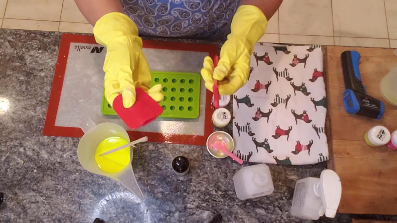 Pouring yellow soap over a small ball mold
