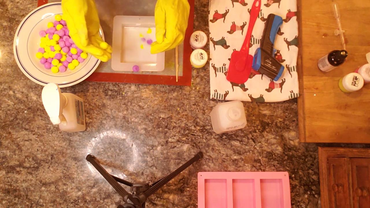 Filling the mold with purple and yellow soap balls