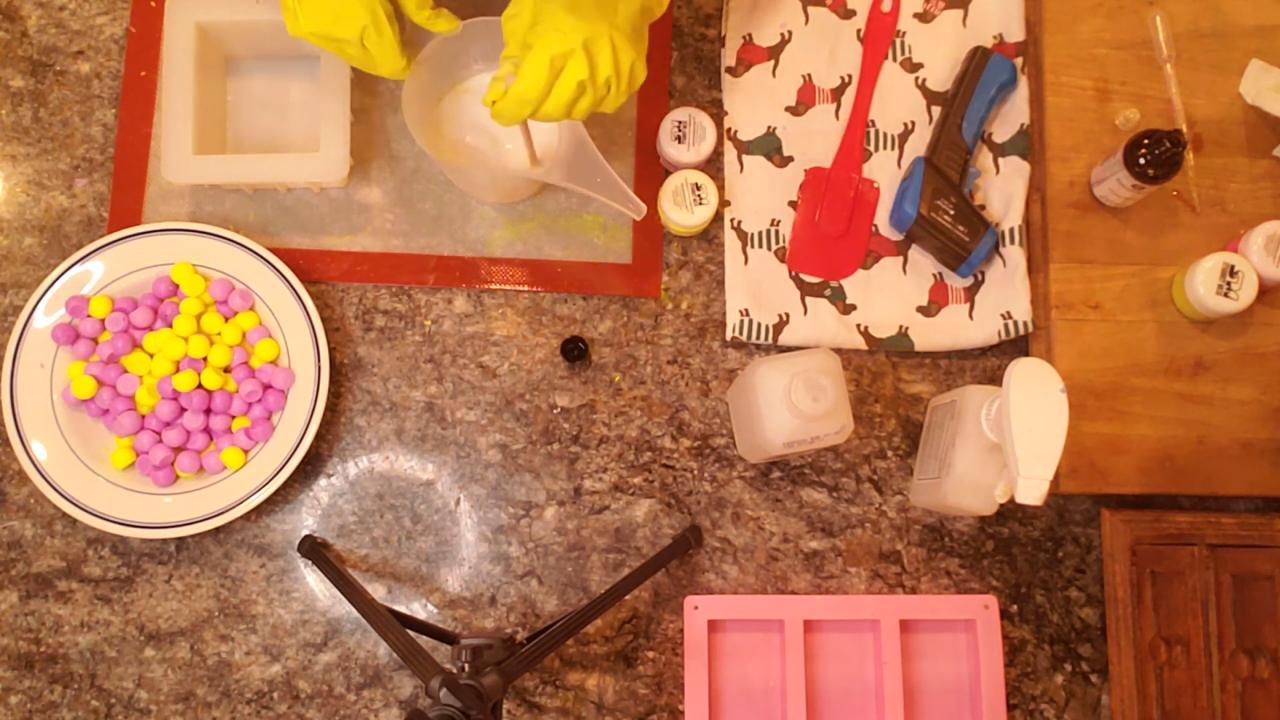 Pouring white shea butter soap into a square mold