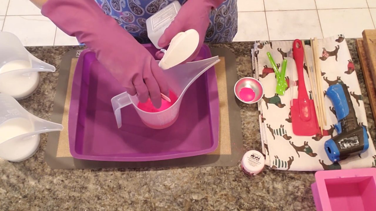 Mixing neon pink mica into melted melt and pour soap