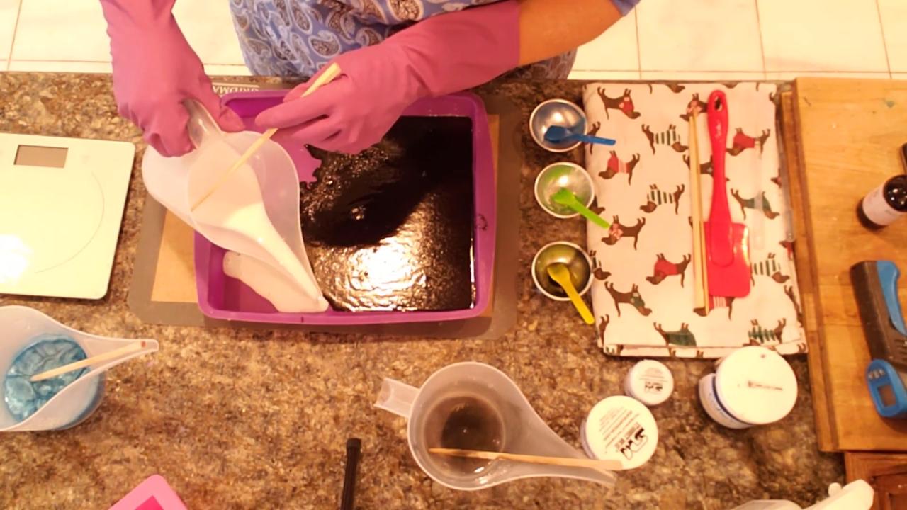 Pouring white shea butter soap over the black layer