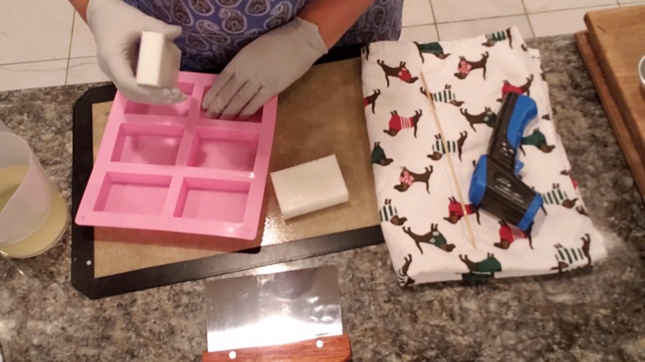Unmolding white goats milk melt and pour soap bars from a pink 6 cavity mold