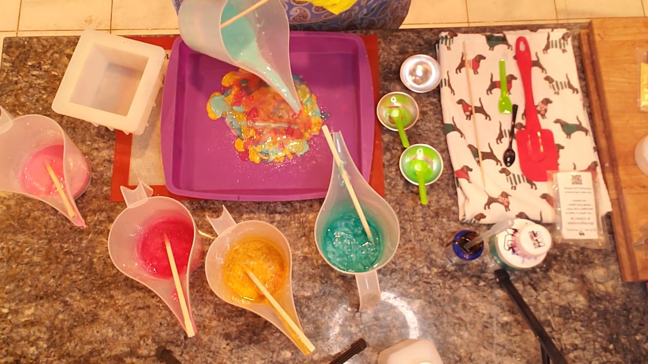 Colorful red, gold and green soap layers poured on a silicone tray