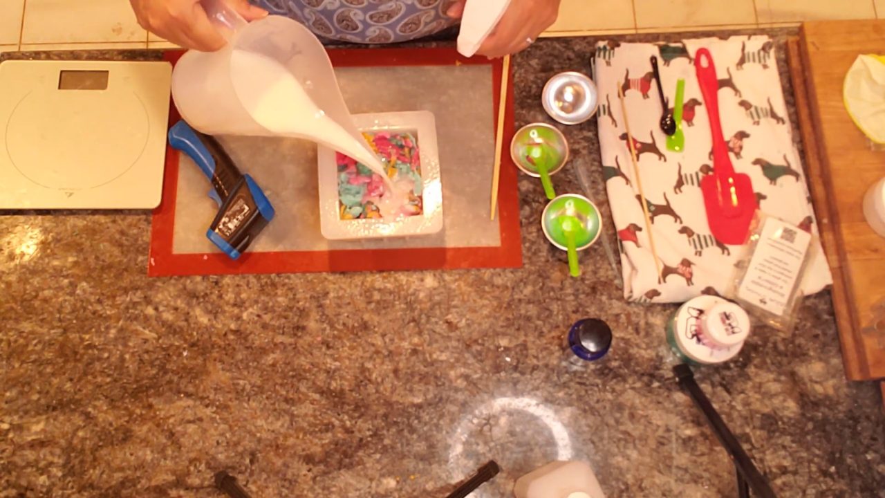 Pouring hot white shea butter soap over the Christmas soap pieces