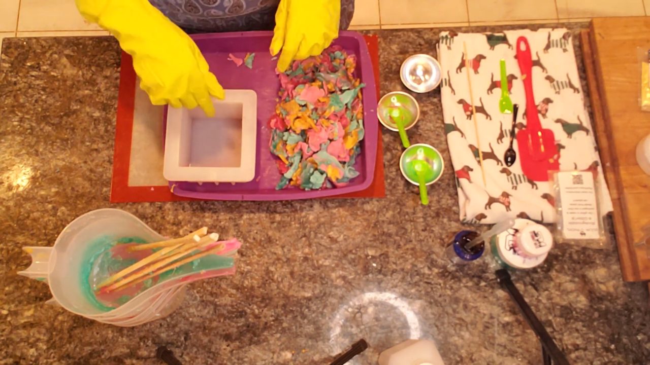 Pressing the mashed Christmas soap into a square mold
