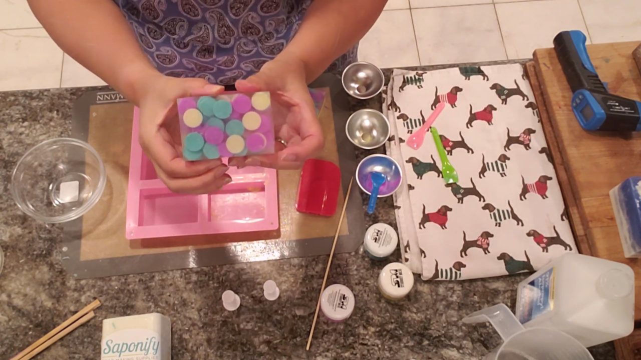 Finished circle embed melt and pour soap with purple, green and yellow circles