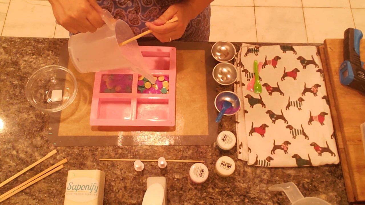 Pouring melt and pour soap over the circle embeds