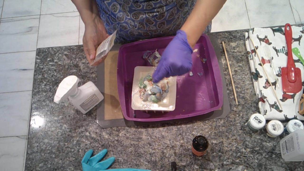 Sprinkling bio glitter on top of the soap