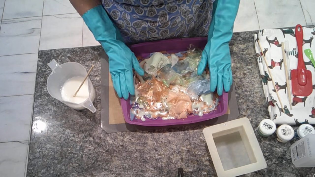 Green, blue and bronze soap pieces in a silicone pan