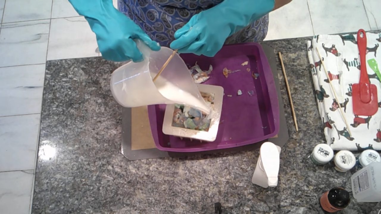 Pouring shea butter melt and pour soap over the colored chunks