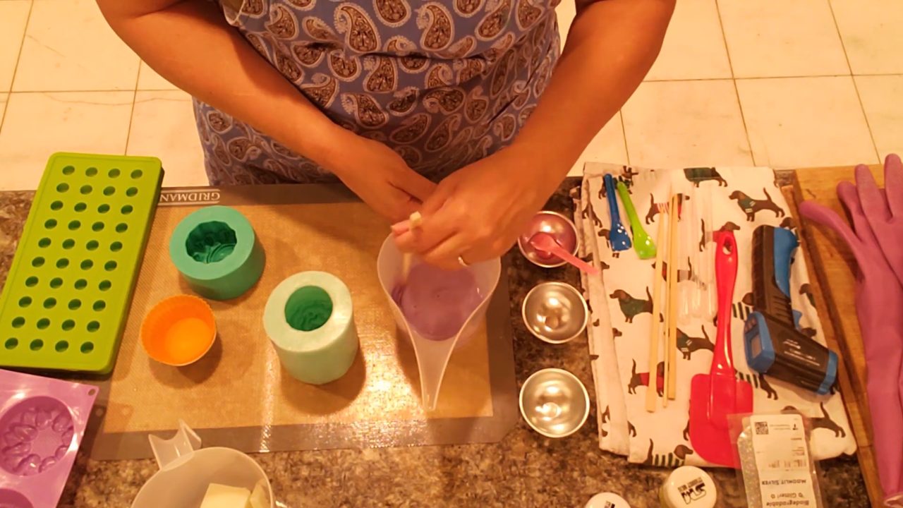 Mixing violet purple mica into melted shea butter soap