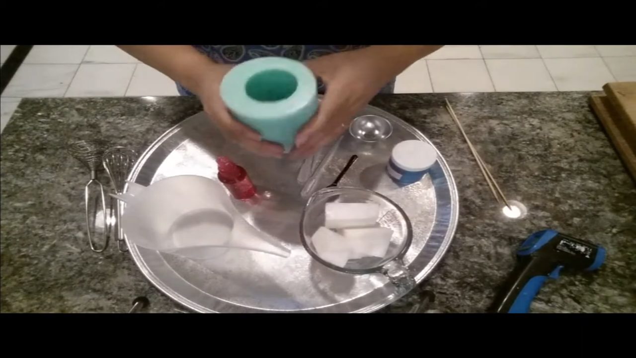 Measuring the frosting section of a giant cupcake mold with water