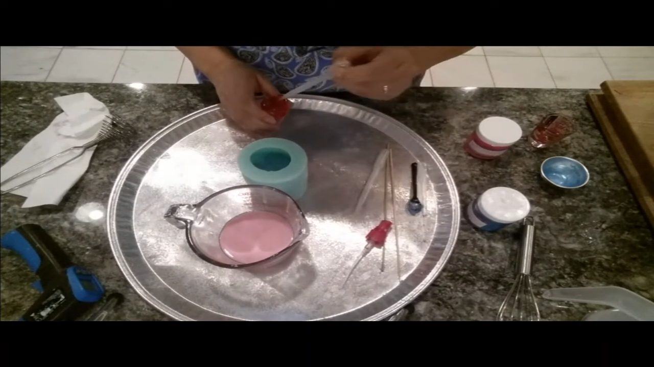 Pouring pink cake soap over the set frosting