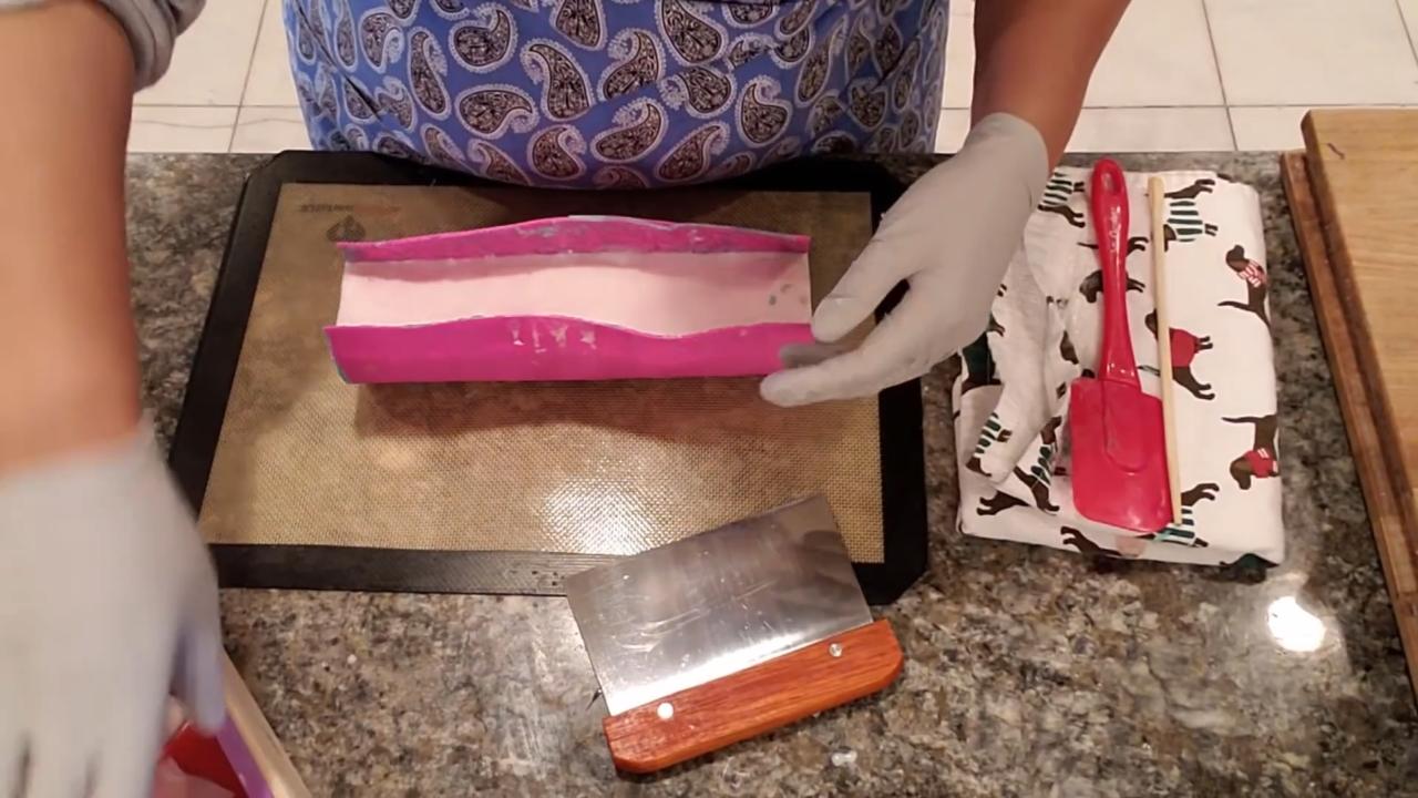 Unmolded soap loaf with a curved patterned top