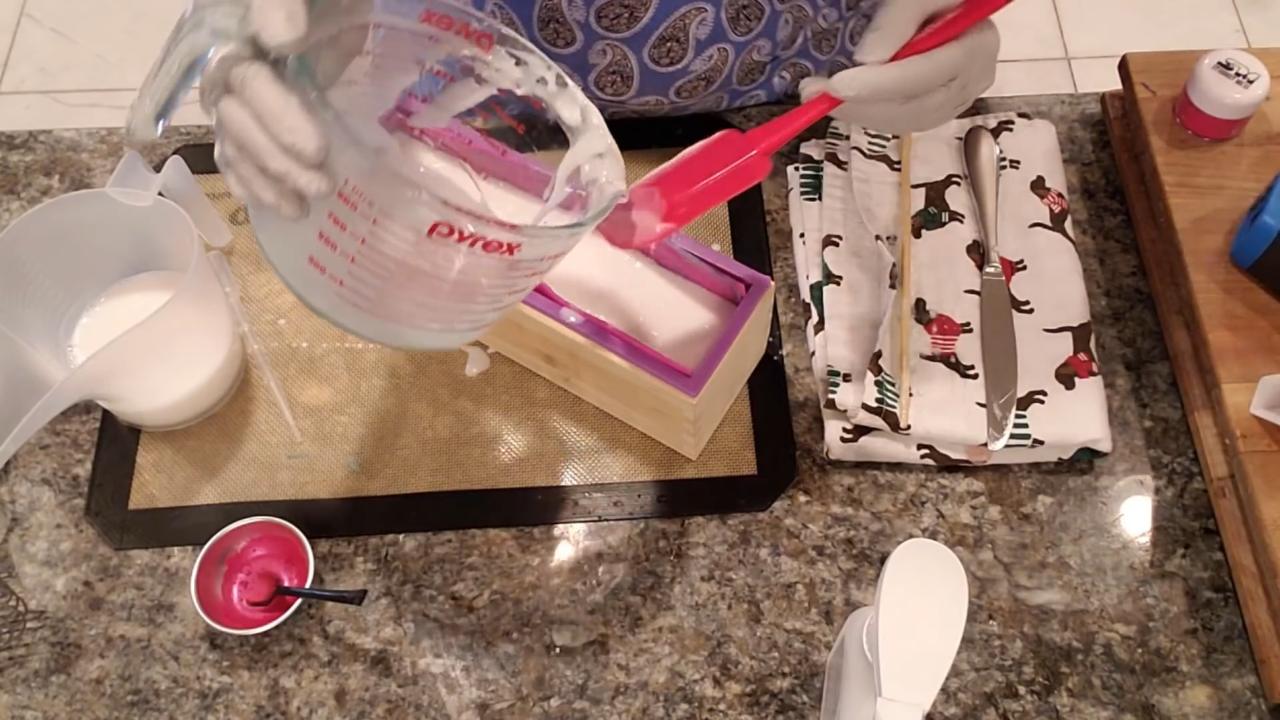 Pouring shea butter soap into the curved mold