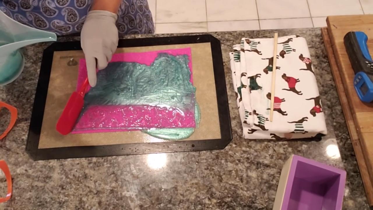 Scraping colored soap off the impression mat