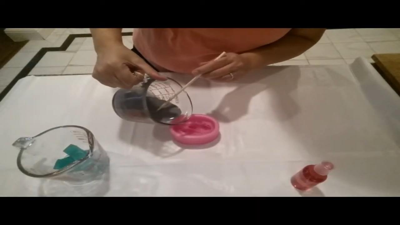 Pouring gray soap into the dolphin silicone mold
