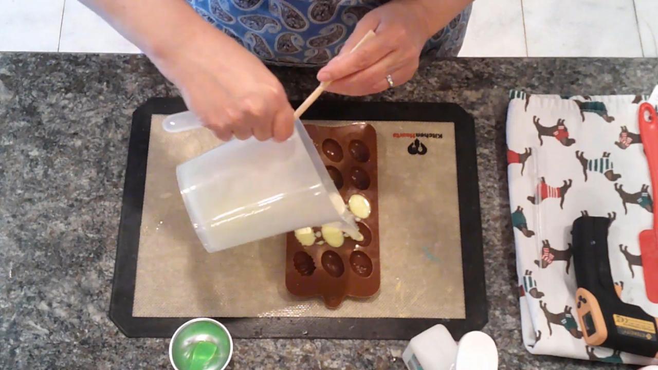 Pouring colored soap into the egg embed mold