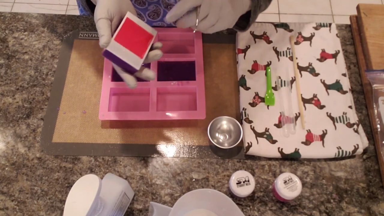 Unmolding stamped melt and pour soap and pulling out the embossing stamp
