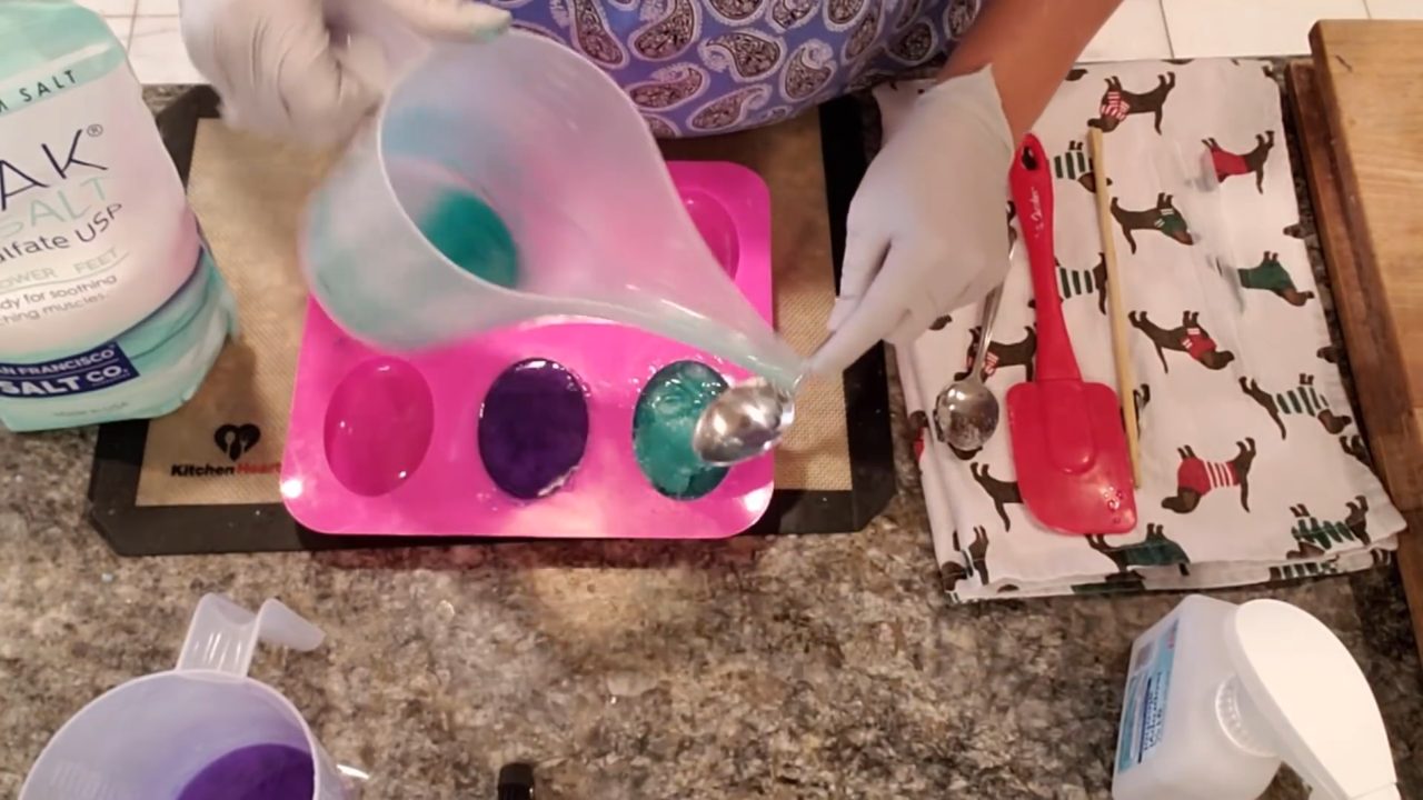 Filling the oval mold with green Epsom salt soap