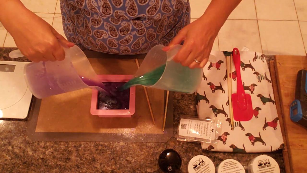 Pouring purple and green soap into the mold at the same time