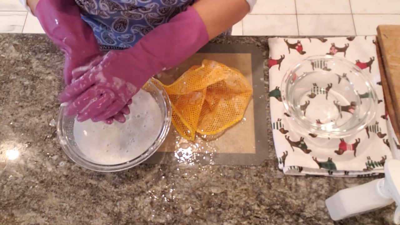 Felting the wool onto the soap with warm water and friction