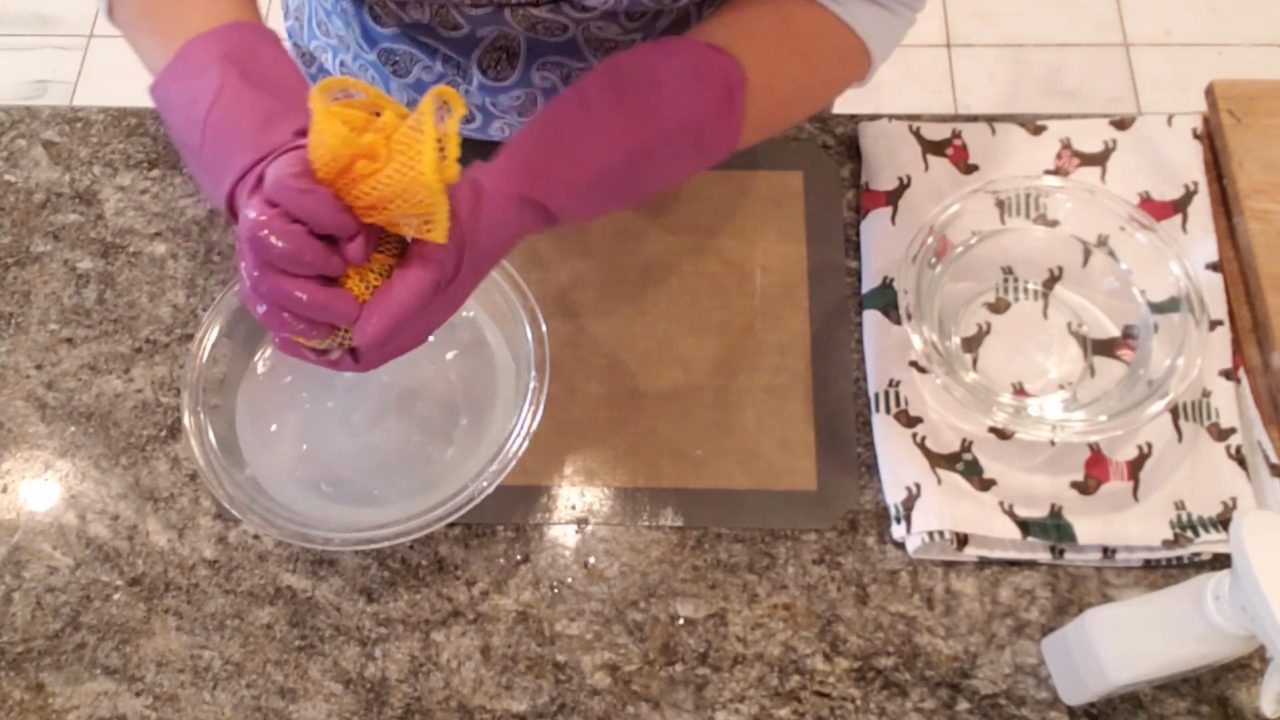 Rubbing the wool-wrapped soap with a mesh scrubber to felt it