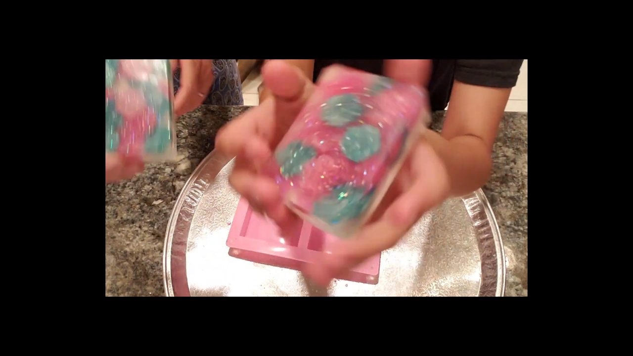 Finished floral embed melt and pour soap with flowers in glittery clear soap