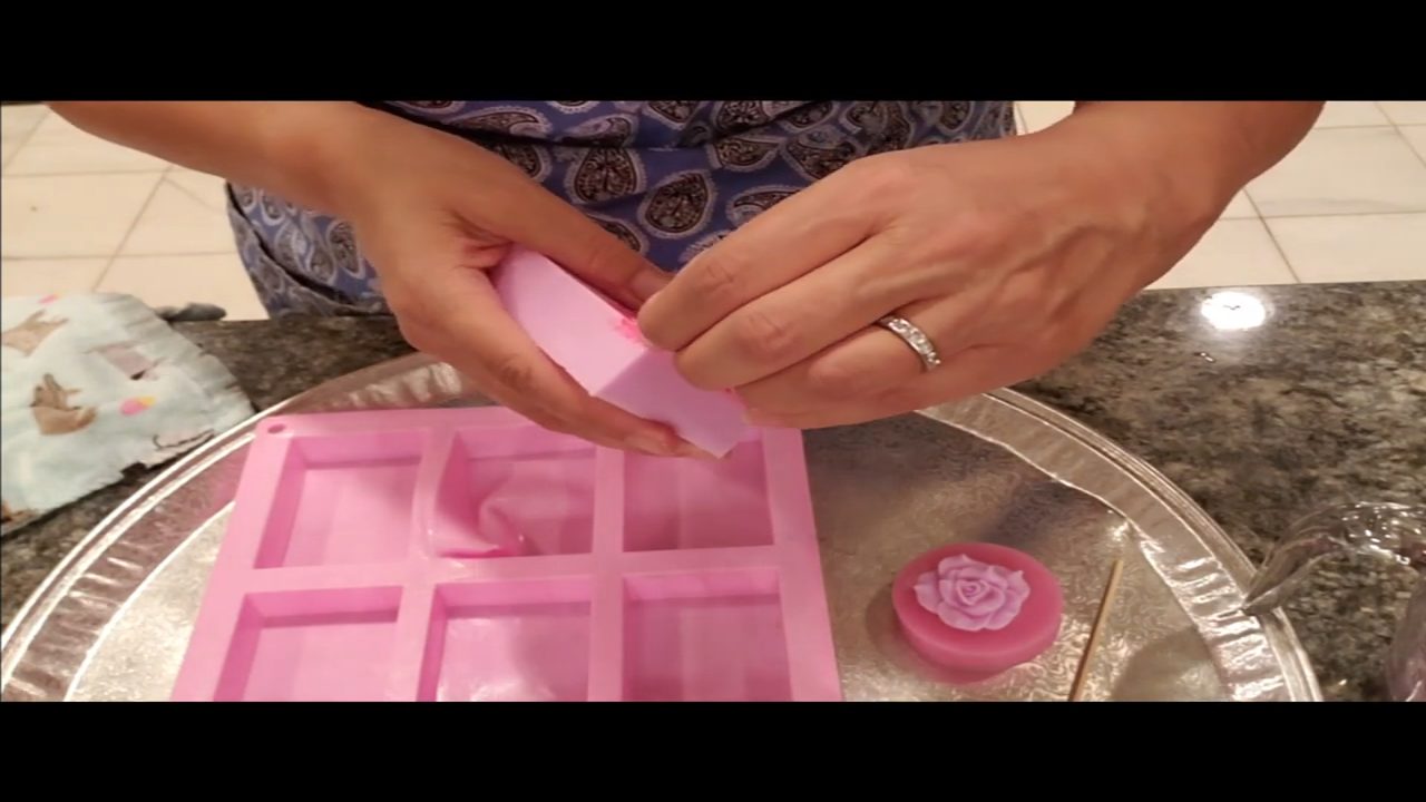 Peeling the fondant lace mat off the pink soap bar