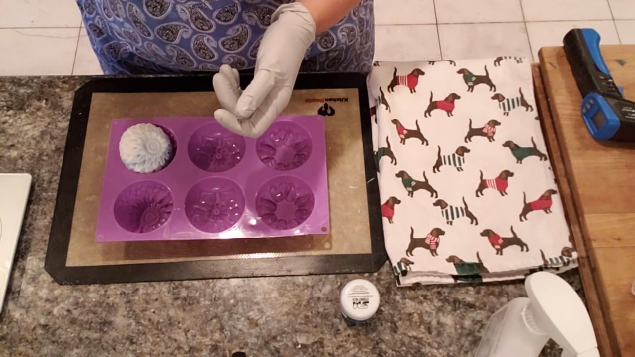 Weighing the finished flower swirl soap on a scale
