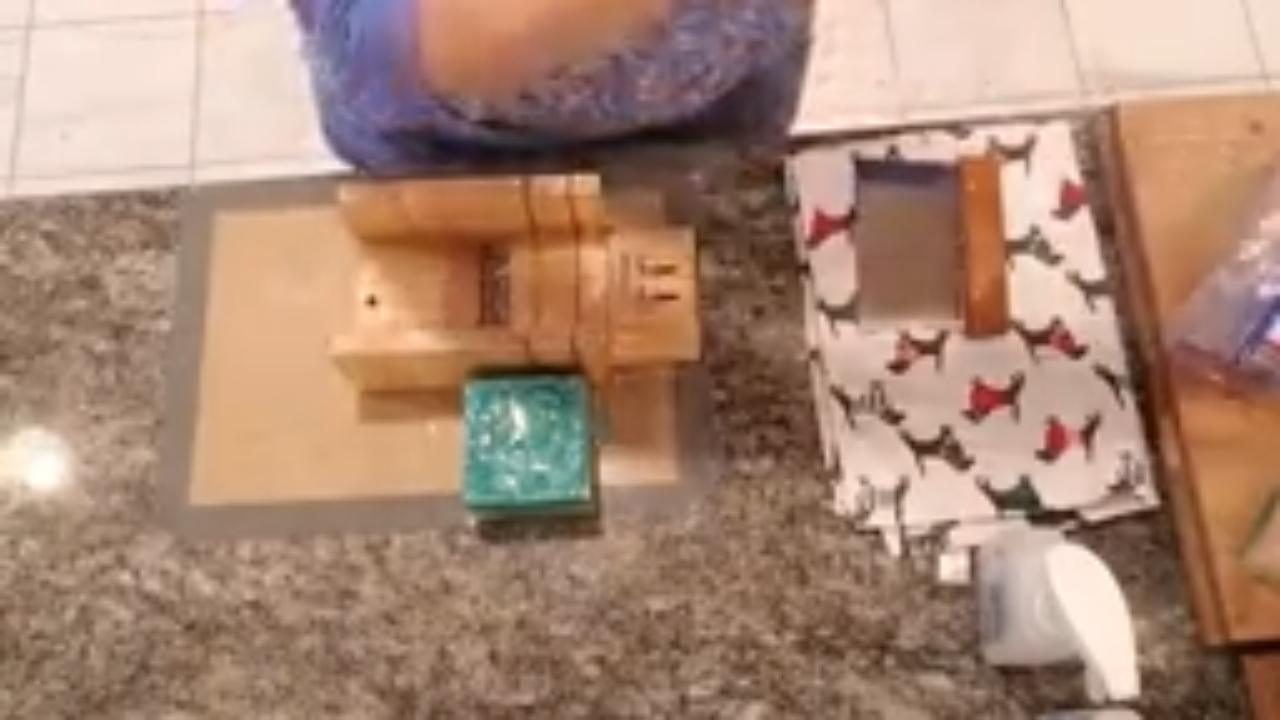 Unmolded green and yellow swirl soap loaf in the cutter