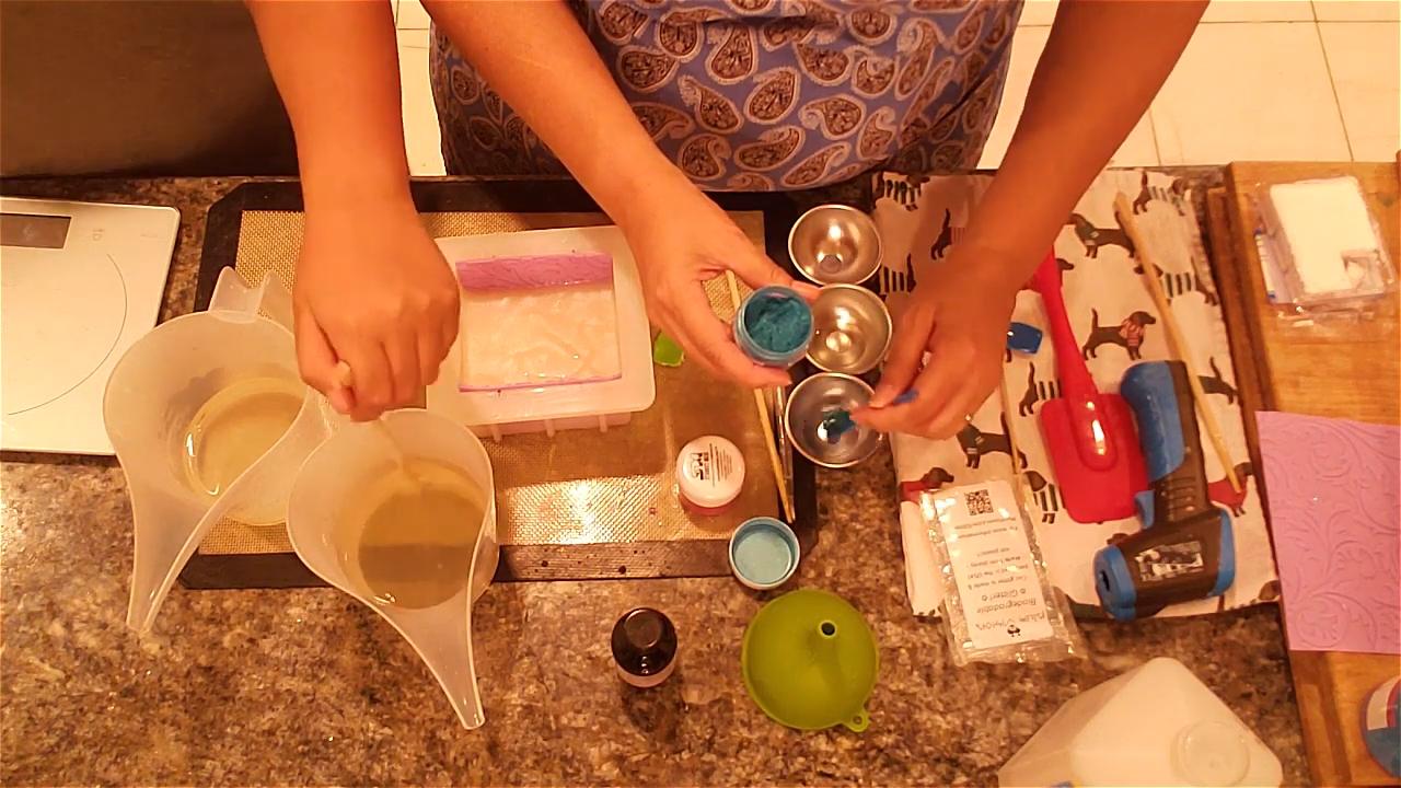 Mixing pink and blue mica into melted soap