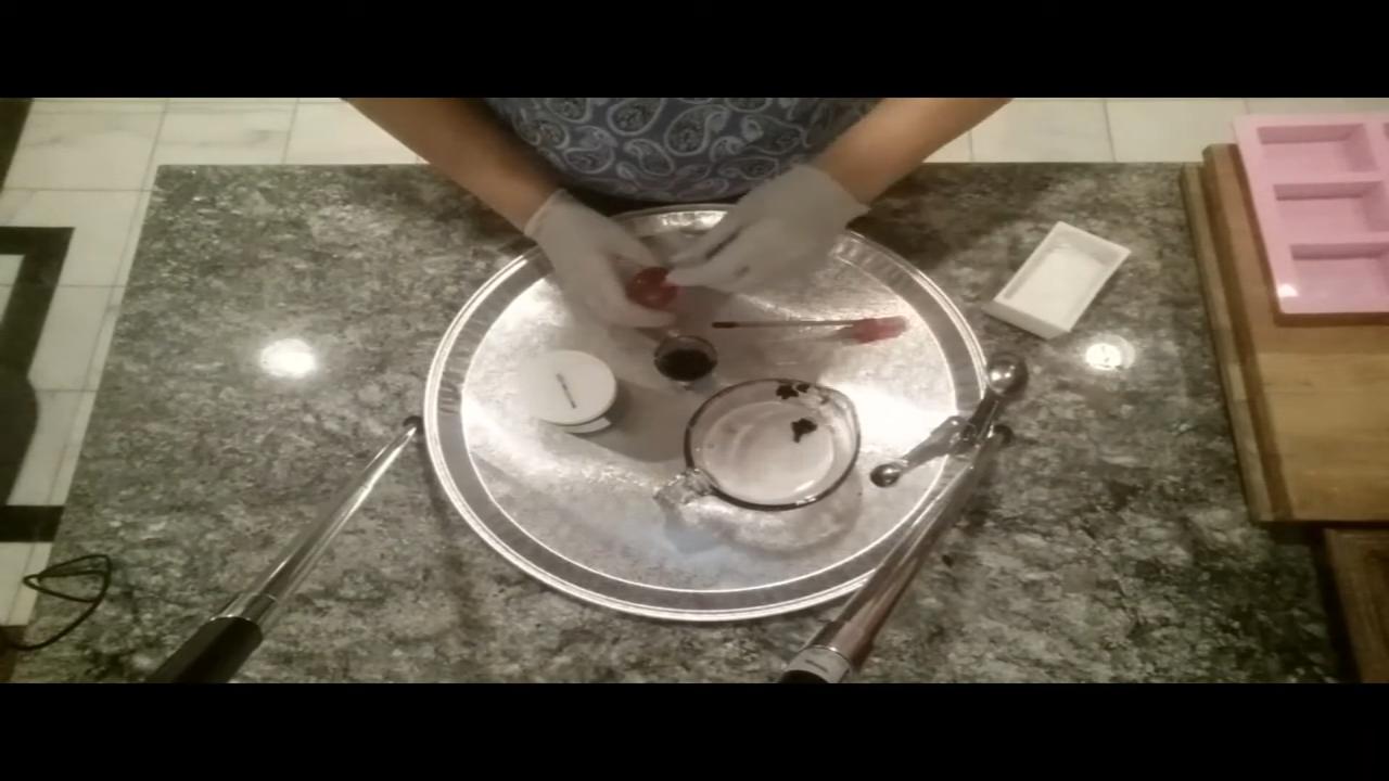 Stirring activated charcoal into the remelted soap