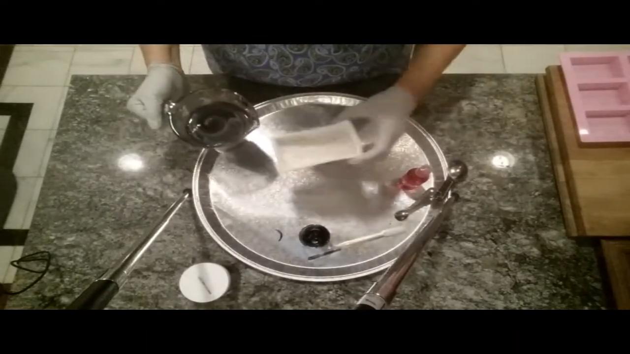 Pouring dark soap into a dragon eye mold
